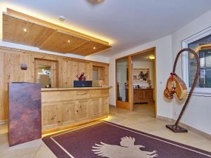 a large room with a kitchen with a swing at Alp Resort Tiroler Adler in Sölden