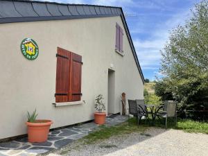 a small house with a table and chairs in front of it at Gîtes de la Ferme Basso in Planès +9 photos