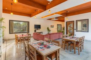 a dining room with tables and chairs at Shivaangan By Soma Estates in Udaipur