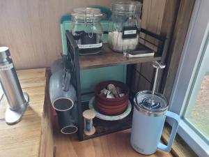 a shelf with jars and other items on it at Moss Haven on Hood Canal in Quilcene