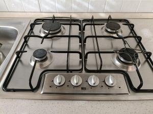 a stove top with four burners on top of it at EDDA - Regarda Travel in Lazise
