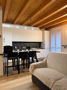 a living room with a table and a kitchen at La Casa di Lella in Paratico