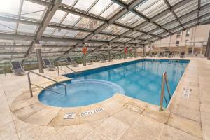 a large swimming pool in a large building at Sheraton Mendoza Hotel in Mendoza