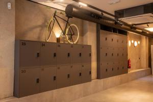 a bike is hanging on a wall in a garage at Hostel Nixar in Almería