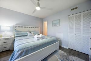 a white bedroom with a bed and a night stand at 4F Amelia Landings in Fernandina Beach +21 photos
