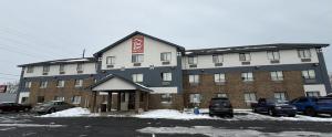 a large building with cars parked in a parking lot at Red Roof Inn & Suites Hammond, IN in Hammond