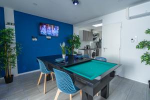 a dining room with a ping pong table at Capsule Océan 2 Chambres- Billard - Jacuzzi - Netflix in Valenciennes