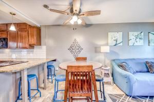 a kitchen and living room with a blue couch at Gulf Shores Barefoot Bliss in Gulf Shores
