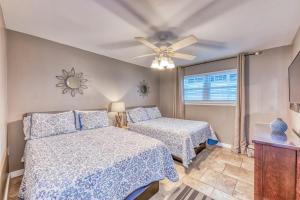 a bedroom with two beds and a ceiling fan at Gulf Shores Barefoot Bliss in Gulf Shores +26 photos