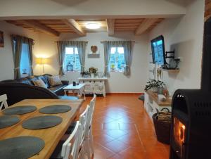 a living room with a table and a couch at Chalupa u Markéty in Jiřetín pod Jedlovou