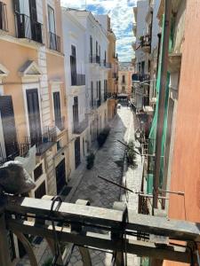 a view of an alley with buildings and a bench at Guiscardo Suites in Bari +6 photos