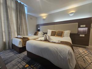 a hotel room with two beds with towels on them at KGT House in Dublin