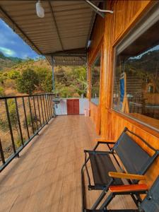a rocking chair on a porch of a house at Căn gentle home in Da Lat