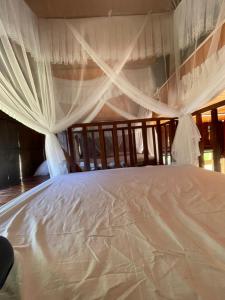 a large white bed with curtains on it at Căn gentle home in Da Lat