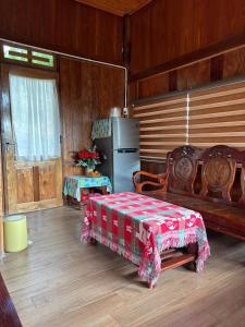 a kitchen with a table and a refrigerator in a room at Căn gentle home in Da Lat