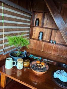 a table with plates of food and a plant on it at Căn gentle home in Da Lat