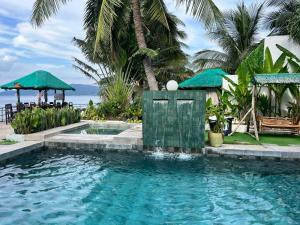 a swimming pool in front of a resort at The Philip Ann Resort in Mabini