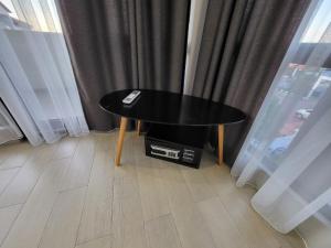 a black table sitting in front of a window at Hotel SABA in Kobuleti