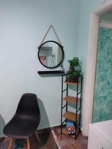 a black chair sitting in front of a mirror at Blue Dreams in Veria