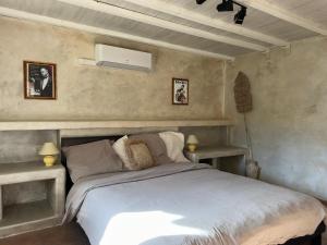 a bedroom with a bed and two lamps and a ceiling at Mas la Provence in L'Isle-sur-la-Sorgue +56 photos