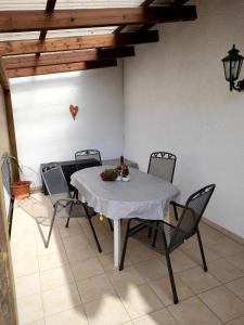 a table with chairs and a bottle of wine on it at Ferienwohnung Leni mit Balkon in Maroldsweisach
