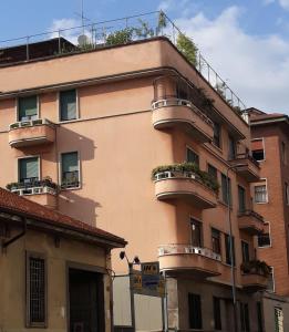 a tall building with balconies and plants on it at Casatitta Bed & Breakfast in Milan