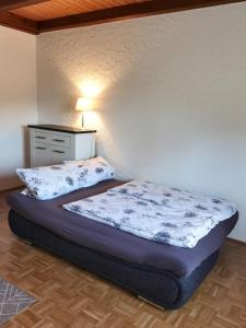 a bedroom with a bed and a dresser in a room at Ferienwohnung Leni mit Balkon in Maroldsweisach