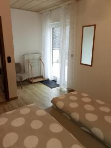 a room with a bed and a window and a rug at Ferienwohnung Leni mit Balkon in Maroldsweisach +2 photos