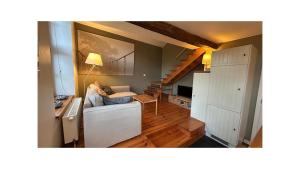 a living room with a couch and a table at Chambre d'Hôtes Les Augustins - Parking sécurisé - Borne de recharge in Huy