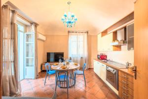 a kitchen with a table and chairs in a room at Palazzo Ciravegna, Alba Duomo View in Alba