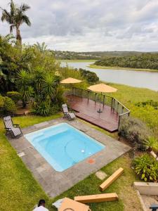 an overhead view of a swimming pool with umbrellas at Bonza Bay Bliss in East London +6 photos