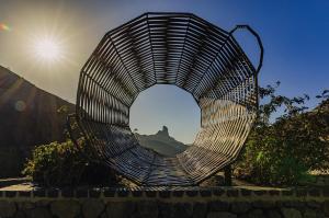 a circular metal sculpture with a view of a statue at TeXeda Room Suites in Tejeda