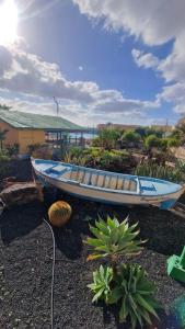 a boat sitting on the ground next to some plants at Wind House in Costa de Antigua