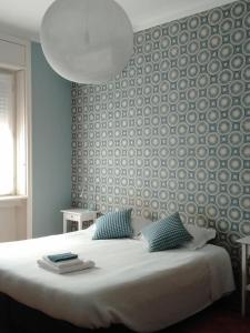 a bedroom with a large bed with a wall at Casatitta Bed & Breakfast in Milan