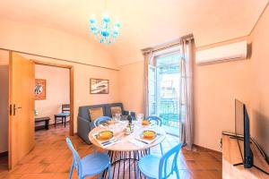 a dining room with a table and chairs and a television at Palazzo Ciravegna, Alba Duomo View in Alba +11 photos