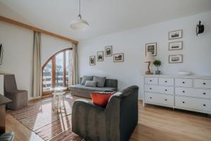 a living room with a couch and a chair at WHY NOT Apartament Krywań in Kościelisko