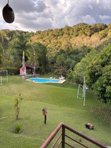 a view of a park with a playground and a pool at Chacára Reni in Itajubá