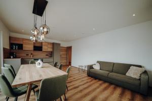 a living room with a table and a couch at Kleinberg Chalet in Filzmoos
