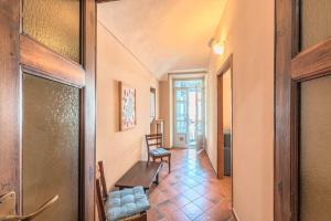 a hallway with a table and chairs in a room at Palazzo Ciravegna, Alba Duomo View in Alba