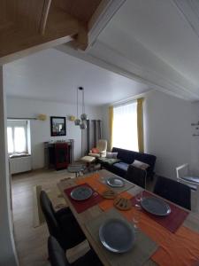 a living room with a table and a couch at La maison de Yo in La Feuillée