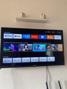 a television screen with a bunch of videos on it at Flat na beira da praia in Maricá