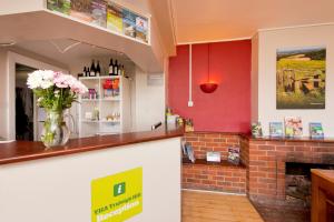 a bar with a vase of flowers on the counter at YHA Truleigh Hill in Shoreham-by-Sea