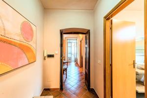 a hallway with a hallway leading to a room at Palazzo Ciravegna, Alba Duomo View in Alba