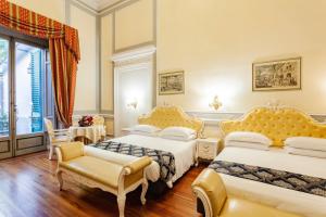 a hotel room with two beds and a window at Villa Royal in Florence +43 photos