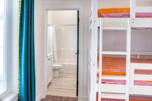a small bathroom with bunk beds and a toilet at Lulu’s Family Lakehouse in Garden City +34 photos