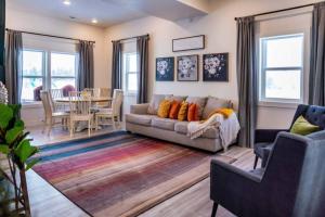 a living room with a couch and a table at Lulu’s Family Lakehouse in Garden City