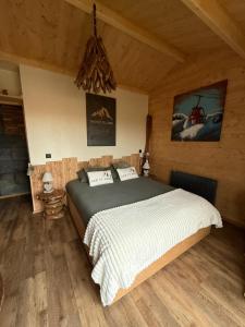 a bedroom with a large bed in a cabin at Coeur de Lodge spa privatif in Cramoisy