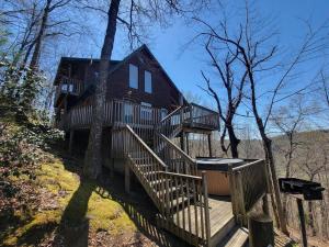 a large wooden house with stairs leading up to it at Mountain Rose- Hot Tub, Pool Table, Firepit in Stanton