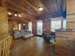 a living room with a couch and a table at Mountain Rose- Hot Tub, Pool Table, Firepit in Stanton