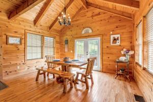 a dining room with a table and chairs in a log cabin at Starry Mountain Night- Private Pool, Pool Table in Stanton